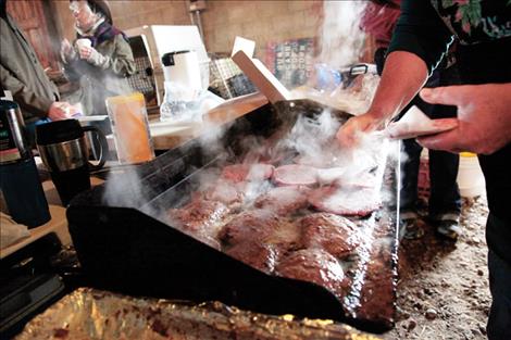Fresh ground beef sizzles on the gril in preparation for lunch at Ag Days.