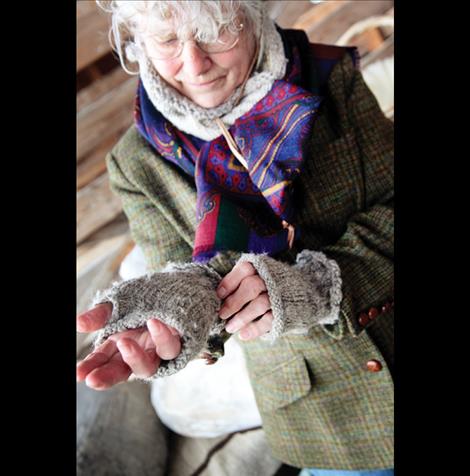 Susan Gardner models her handmade wool mittens for students.