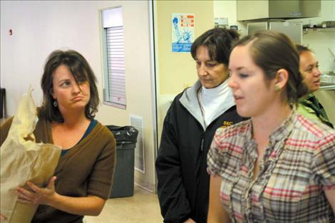 Lindsay Howard (left) and Shay Farmer (right) explain the process of cooking lentils