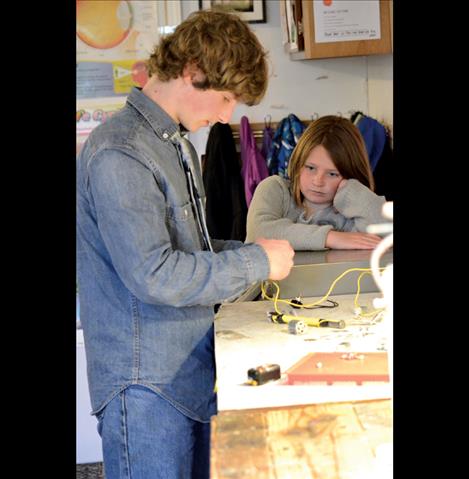 Gabe Moxness, 13, works with a battery-powered magnet