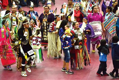 People of all ages gather together and dance.