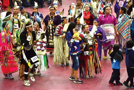 People of all ages gather together and dance.  