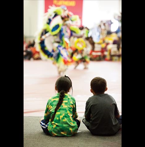 Young boys watch dancers.
