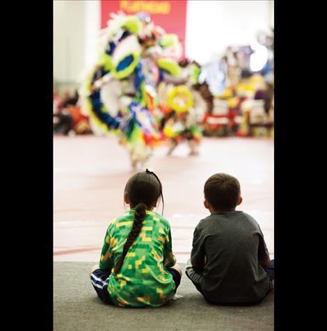 Young boys watch dancers.  