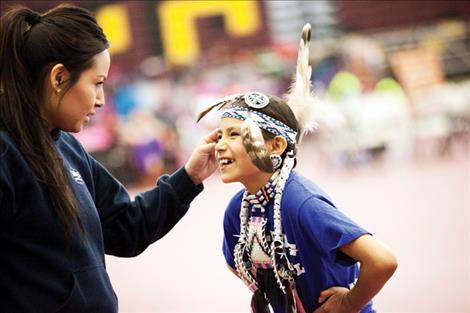 Mother Chelsea Brave Rock examines her daughter, Cedar Hunt’s, headband.