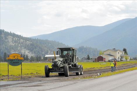 Salish Kootenai College students finish a new pedestrian path in Arlee, along Jocko Road. 