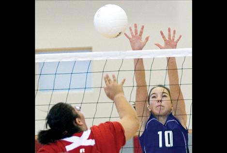 Mackenzie Foust attempts a block during district play.