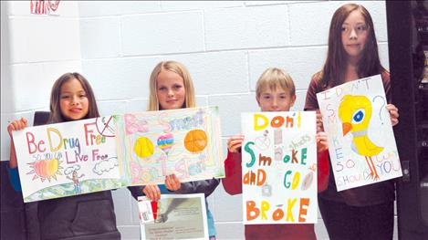 Polson Middle Schoolers Ella Anderson, Ashlynn DePoe, Braedon Iliff and Carly Garrick display their prize-winning anti-smoking posters.