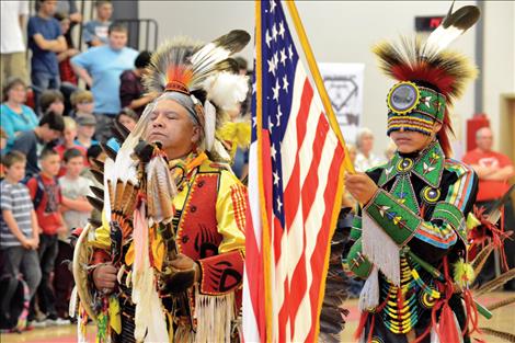 Allen Pierre and Ardon McDonald, 14, present the flag during the grand entry.