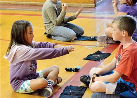 Third-grade students play traditional games during Arlee’s cultural day. 