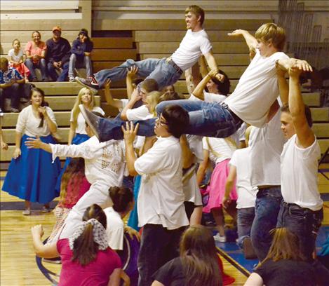 Students perform choreographed dance routines to each song.