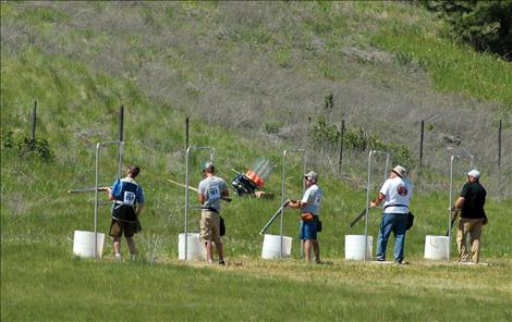 Participants in the five-stand competition enjoy good weather as they wait for their clay birds.