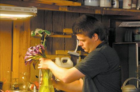 John Romero works in St-Char-Ro, the flower shop he partially owns with his family. 