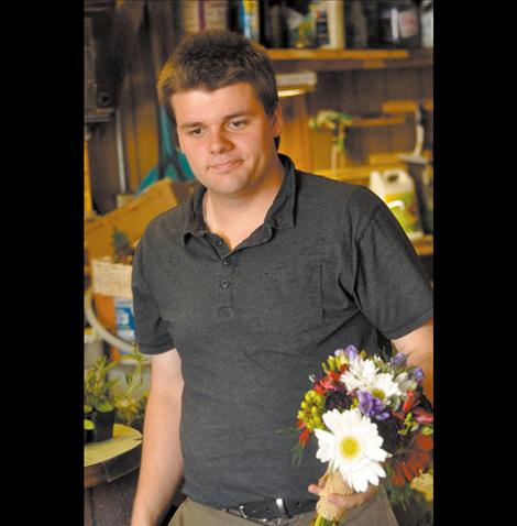 John Romero works in St-Char-Ro, the flower shop he partially owns with his family. 