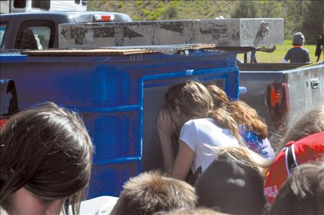 Students peer into a tank of fish. 