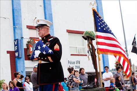 Marine veteran Chuck Lewis walked in the Polson parade with a battle cross to remember members of the military who gave all.