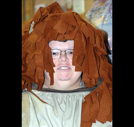 Chris Garcia plays the cowardly lion with a wonderful roar and swish of his tail.