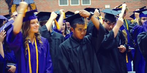 The class of 2015 moves the tassels on their mortarboards, which signifies they’re officially graduates.