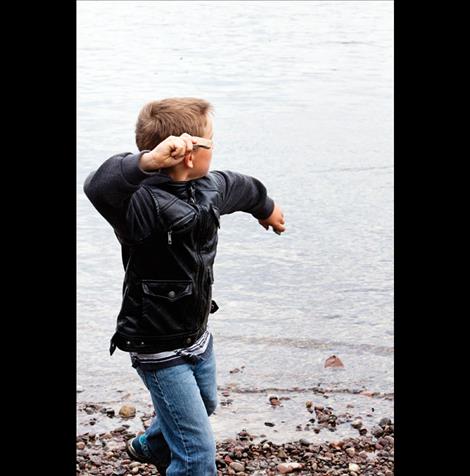 A young rock skipper, upper left, winds up.