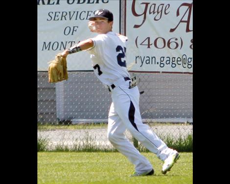 Kade Schutzmann rounds up a loose ball in the outfield. 