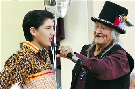  T.J. Felsman sings with teacher Stipn Smallsalmon during his eighth-grade graduation ceremony.