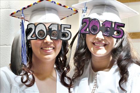 Graduates Emilie Charlo and Camaleigh Old Coyote celebrate graduation day in spectacles.