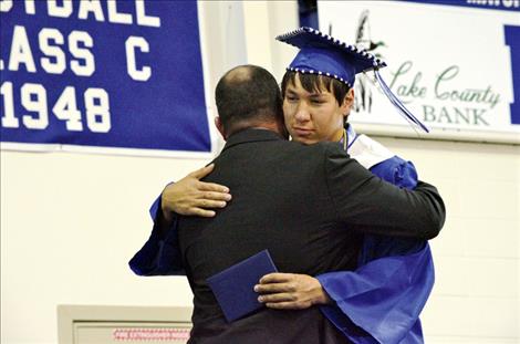 Raymond Matt receives his diploma from his father, school board trustee Peter Matt.