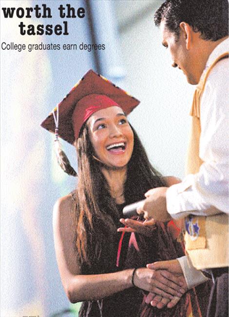 Salish Kootenai College graduate Ciera Kennedy accepts her diploma from college president Robert R. DePoe III.