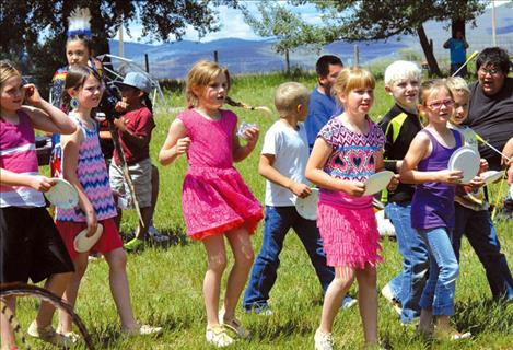 Students have a plate with a number on it for the cake dance. When the announcer calls a number, the student with that number receives a cupcake.