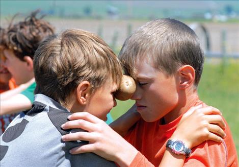 Mason Sloan and Trapper McAllister  concentrate on keeping the potato between their  foreheads during  the potato dance.