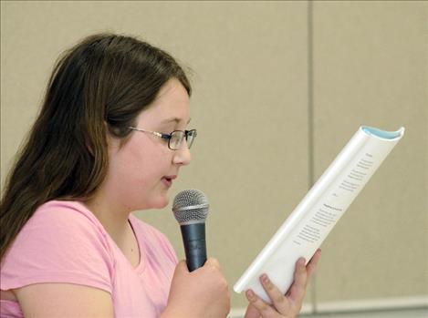 Annalysia DuMontier, 11, reads her poem about food and the body. “My eyes are grapes,” she said.