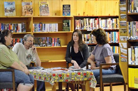 Library board members and volunteers discuss the summer reading program. From left are Dori Knoll, Jay Kirby, Andrea Brister and Susan Black.