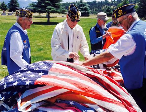 American Legion members sort through worn flags.