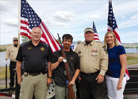 The Veterans Honor Guard raffle event included, from left, Sheriff Don Bell, winner Darrel Rogers, Russ Harbin, and Mayor Heather Knutson.