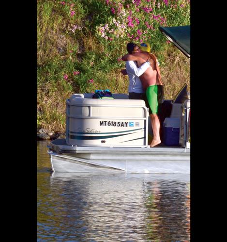 Mark gives wife Dana a hug before starting his swim at 6:30 a.m.