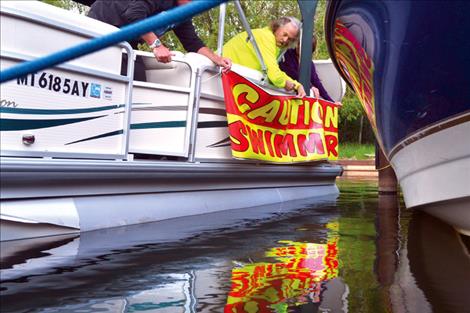 Mike McCormick helps prepare the support boat before launching.