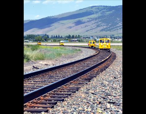 Railcars nicknamed "speeders" travel on Montana Rail Link line south of Arlee.