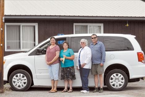 In-Home Service Manager Nancy Roark, Project Director Joanne Shaw, Transportation Coordinator Keith Gaffaney and Transportation Coordinator Jen Johnson stand with a new handicap-accessible van purchased through a state program.