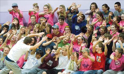 Fans sporting pink in honor of breast cancer awareness get fired up at Polson’s “pink-out” volleyball game.