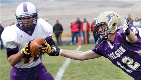 Laurel’s Mitch Kaufman intercepts the ball as Polson’s Brady Hislop stretches to catch it. The turnover gave the Locomotives the ball at the Laurel 1-yard line.