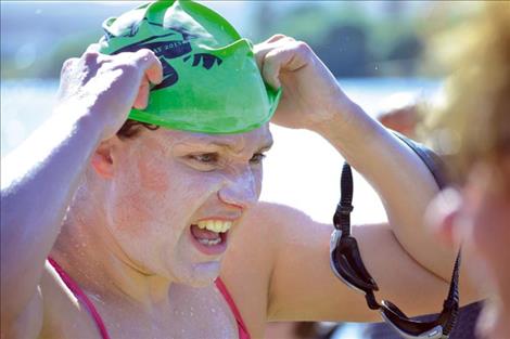 Sarah Thomas removes her goggles and swim cap after walking onto shore. Craig Lenning arrives on shore about two hours after Sarah still wearing Desitin diaper rash cream. 