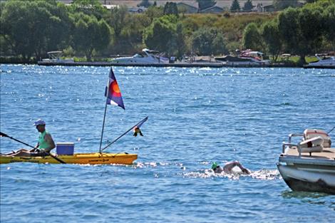 Open-water swimmer Sarah Thomas nears Riverside Park in Polson Friday, completing a 13-hour swim.