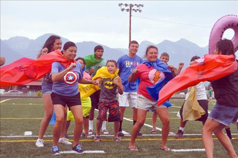 Cape-clad members of the Family Ties team compete in a dance-off.  