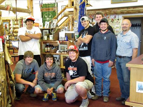 Ronan High School students in the shop class taught by Hap Cheff, right, pose next to wooden display shelves they created for the Ninepipes Museum  of Early Montana.