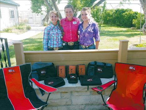 Courtnee Clairmont, Laurel Rigby, and Josey Motichka pose with prizes won at a livestock judging camp. 