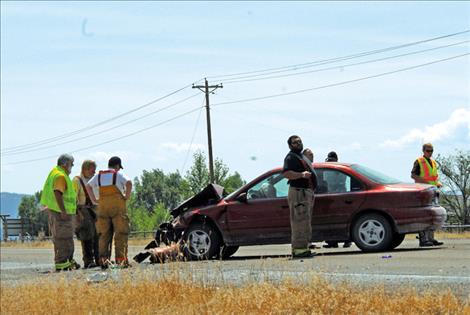 The front end of a car turning left on Ashley Creek Road south of Ronan shows the effects of the crash.