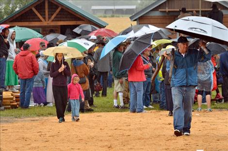 A sea of umbrellas keep people dry as they stake out their bid lots. 