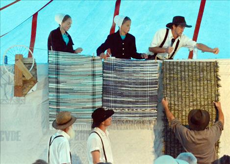 Many folks stayed dry underneath a tent while bidding on quilts.