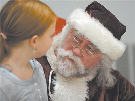 Santa Claus chats with Kiera Den Dekker at the Christmas  dinner Dec. 25.