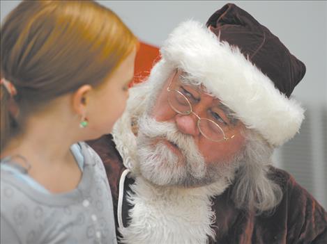 Santa Claus chats with Kiera Den Dekker at the Christmas dinner Dec. 25.